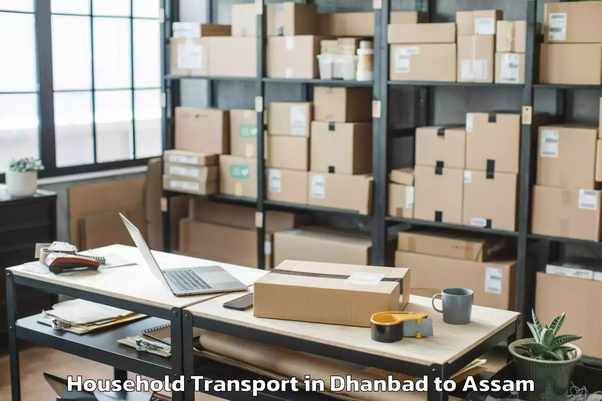 Dhanbad to Marigaon Household Transport Booking